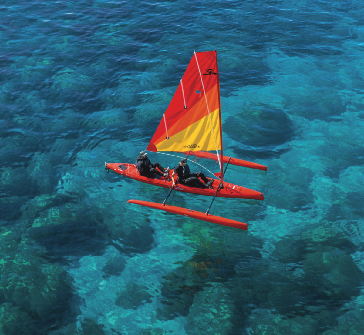 a colorful kite sitting on top of a body of water